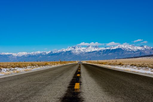 A long road in Colorado leading to the Rocky Mountains