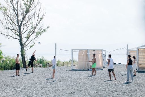 A group of young people playing volleyball on the beach at Lake Sevan, Armenia