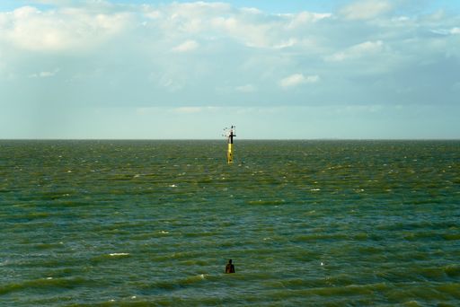 The Anthony Gormley's statue Another Time in the sea just off the coast at Margate in the UK