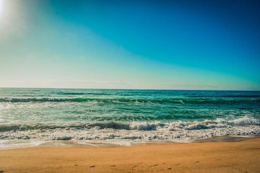 A beautiful relaxing shot of the beach with a beautiful blue sky on a sunny day