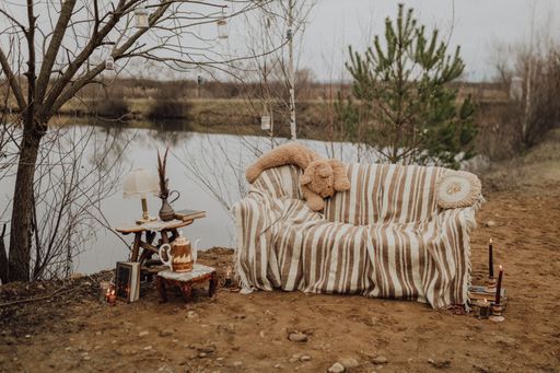 The sofa with candlelight and teapot by the lake