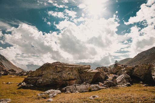 A beautiful view of rocky hills under a sunny cloudy sky in Col de Larche, France