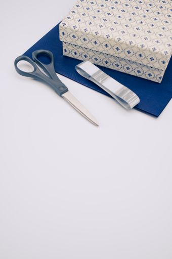 blue paper and decorated box on white background with text space and stationery