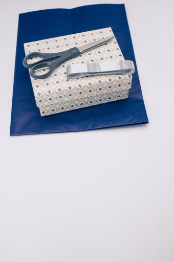 blue paper and decorated box on white background with text space and stationery