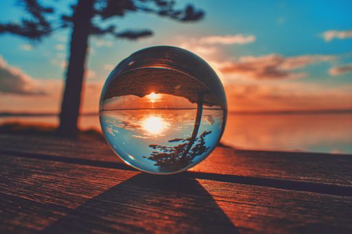 A creative crystal lens ball photography of the beautiful sunset at a lake