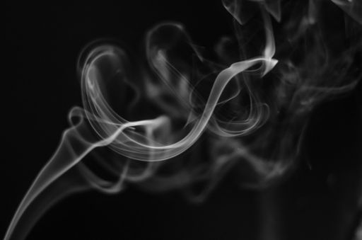 A closeup shot of white smoke with black background