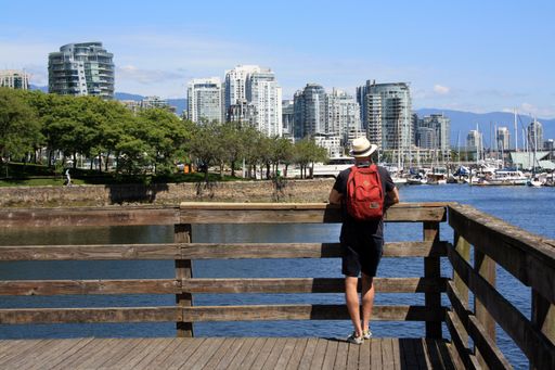 A man with looking from the wooden pierce at Vancouver downtown, British Columbia, Canada
