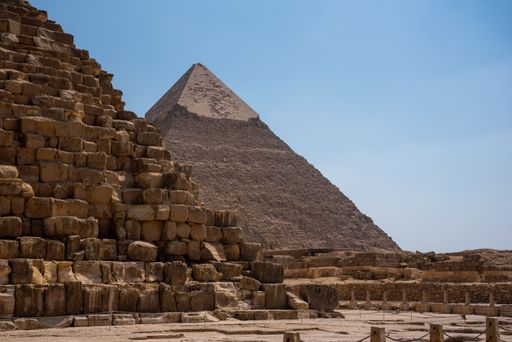 A scenic view of the Great Pyramids of Giza under a clear blue sky, showcasing ancient architecture in Egypt