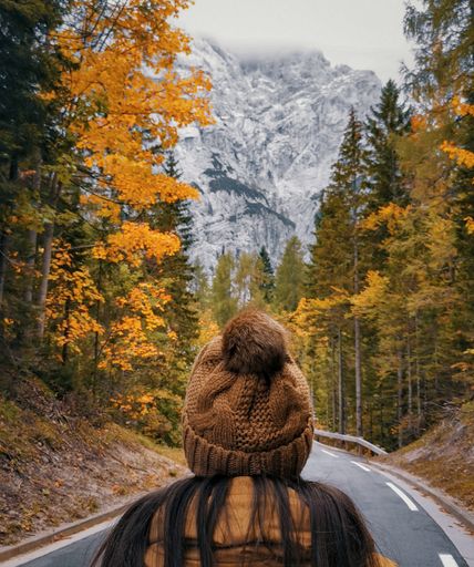 A back view of a woman walking on Vrsic mountain pass road in Julian alps in Slovenia