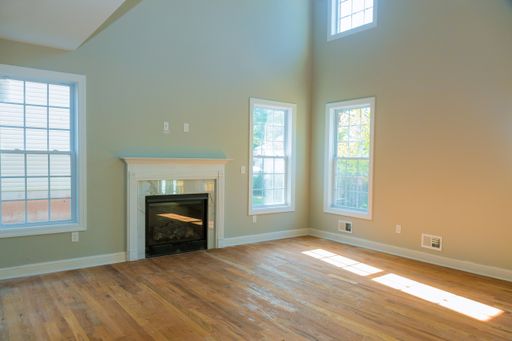 A beautiful interior wide shot of an empty large modern house living room with a fireplace