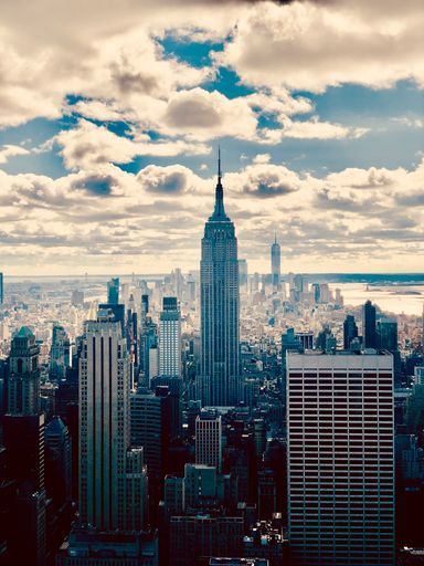 The Lower Manhattan downtown skyline with famous Empire State Building and skyscrapers in New York