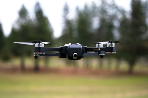 A shallow focus shot of a drone flying at the ranch in California with a blurred background