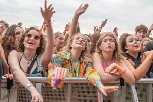 A crowd of young people having fun with the hands up at Boardmasters Festival
