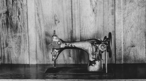 A grayscale shot of an old sewing machine