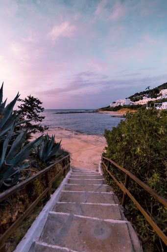 A beautiful vertical shot of stairs leading to the seashore