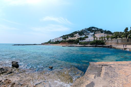 A beautiful scenery of a resort town on the hill and a sea