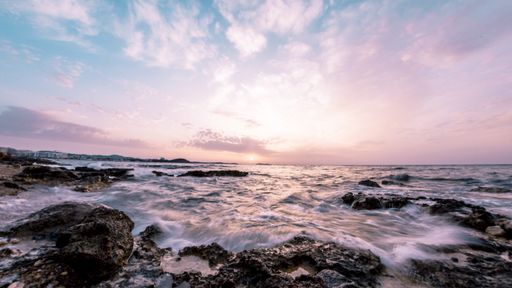 The beautiful sea waves on rocks and stones shot with long exposure