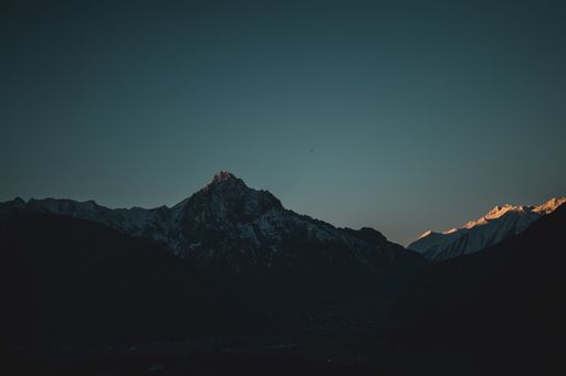 A beautiful view of a snowy Mount Kazbek in Georgia, Caucasus under a dark blue sky