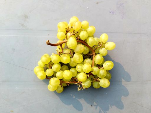 A closeup shot of a diamond grapes in a grey table