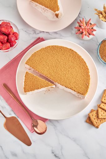 A top view of no-bake triple chocolate mousse cake, strawberries, and other ingredients