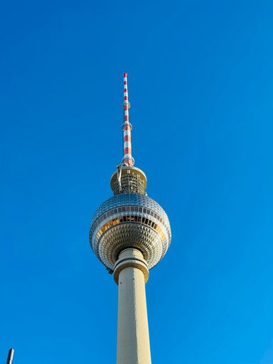 The TV Tower "Alex" against the blue sky. It is one of Berlin's most famous landmarks and is the highest structure in Germany.