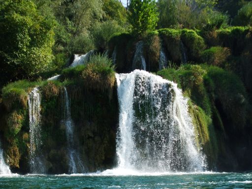 A beautiful shot of waterfalls with green rocky mosses n Krka National Park in on a daylight
