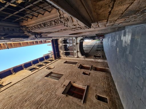 A vertical shot of Carrer del Bisbe and Bishop's Bridge in Barcelona, Catalonia, Spain