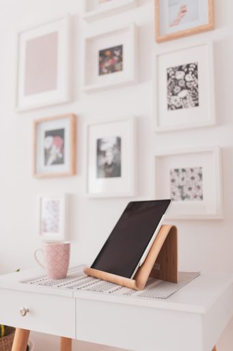 A vertical closeup shot of a tablet set on a bedside table