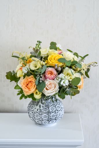 A closeup shot of a beautiful flowers arranged in a vase on a table