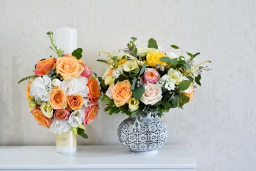 A closeup shot of a beautiful flowers arranged in a vases on a table