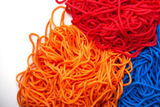 A closeup shot of soft threads in blue, red, and orange colors
