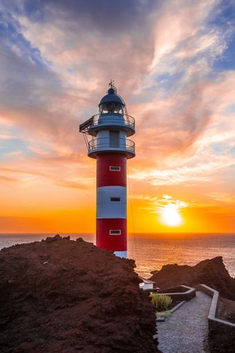 A vertical shot of Punta De Teno Lighthouse captured during the beautiful sunset in Tenerife, Spain