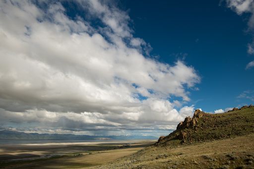 A stunning landscape of Antelope Island State Park in the US state of Utah under a cloudy sky.