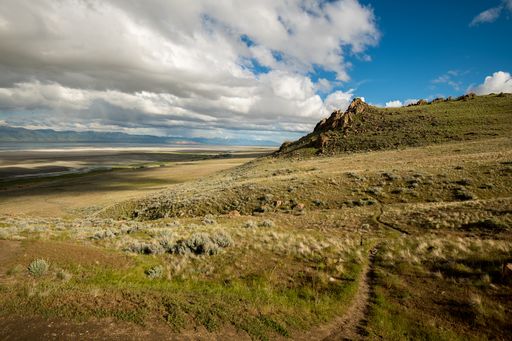 A stunning landscape of Antelope Island State Park in the US state of Utah under a cloudy sky.