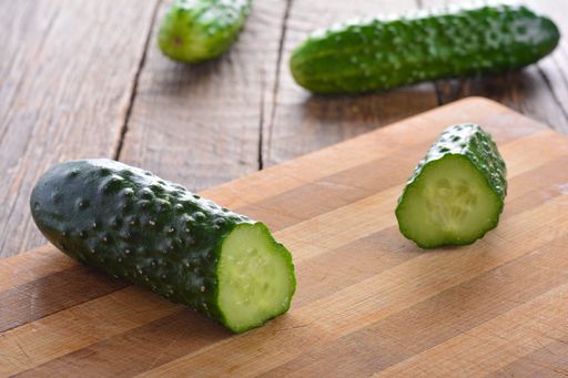 A closeup shot of fresh cucumber on a cutting board