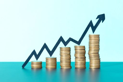 Stacks of coins and rising arrow indicating positive financial growth, business success concept. Copy space