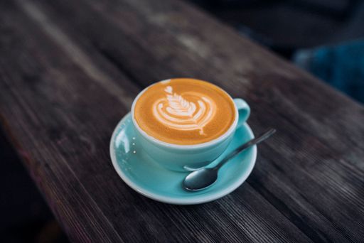 A high angle shot of a delicious cappuccino on a wooden table