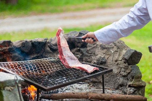 A chef preparing the barbecue on fire