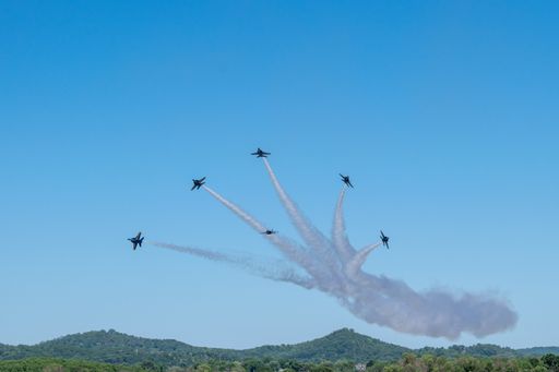 A group of flying aircraft against a clear sky during the National Air Show in Cleveland, USA