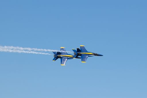 A group of flying aircraft against a clear sky during the National Air Show in Cleveland, USA