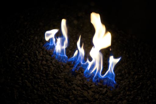 A closeup of burning fire flames on small rocks
