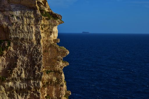 A beautiful shot of coralline limestone sea cliffs in Migra il-Ferha, Maltese Islands, Malta on a sunny day