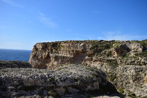 A beautiful shot of coralline limestone sea cliffs in Migra il-Ferha, Maltese Islands, Malta on a sunny day