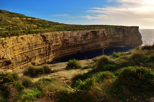 A beautiful shot of coralline limestone sea cliffs in Migra il-Ferha, Maltese Islands, Malta on a sunny day