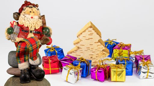 The Santa Clause, gift packages and a tree isolated on a white background
