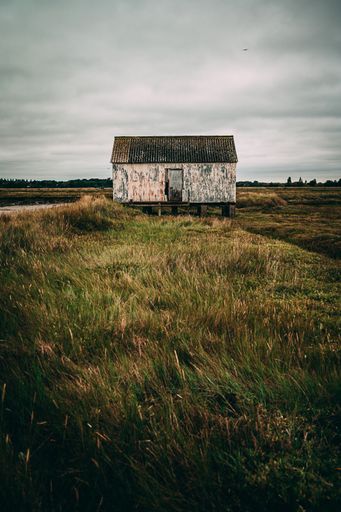 A hut on the shore during a cloudy day