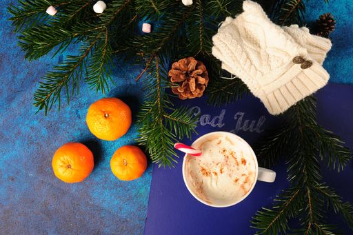 A Top view of "God Jul" Christmas greeting on a blue blackboard