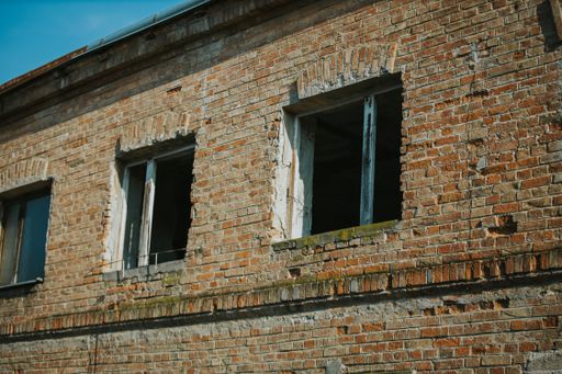 A closeup of an old brick wall building from the outside
