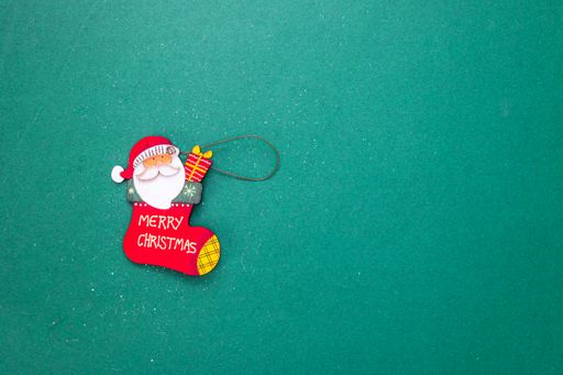 A flat lay of a small Christmas toy decoration with a backgroung copy space