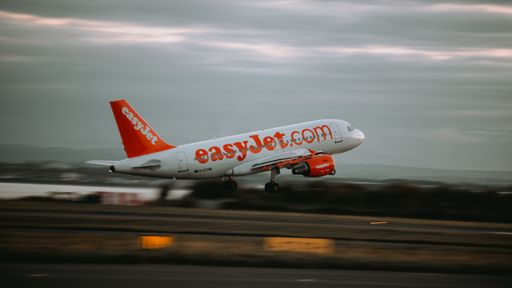 An easyjet airplane a320 taking off at sunset in John Lennon Airport, Liverpool, United Kingdom